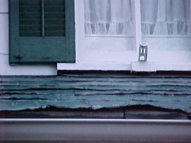 Front porch damaged tin shingles