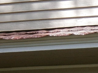 Close of red shingle roof edging