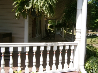 Porch detail includes traditional red tint