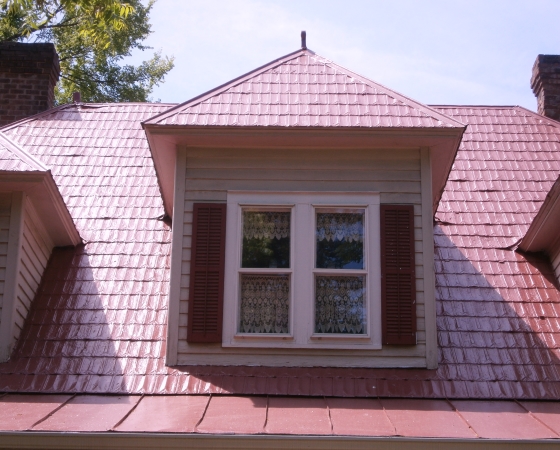 Middle dormer with curtains, shutters and red shingle roof by Roof Menders