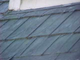 Asphalt coated metal roofing